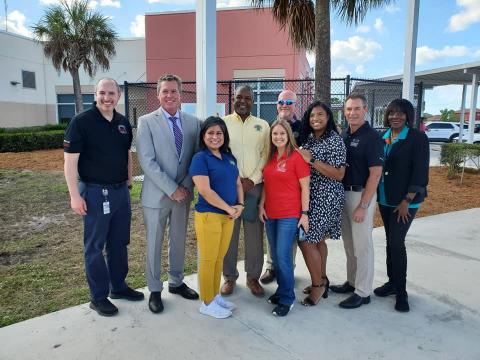 Leaders smile for a photo at a WiFi distribution event in Belle Glade, FL
